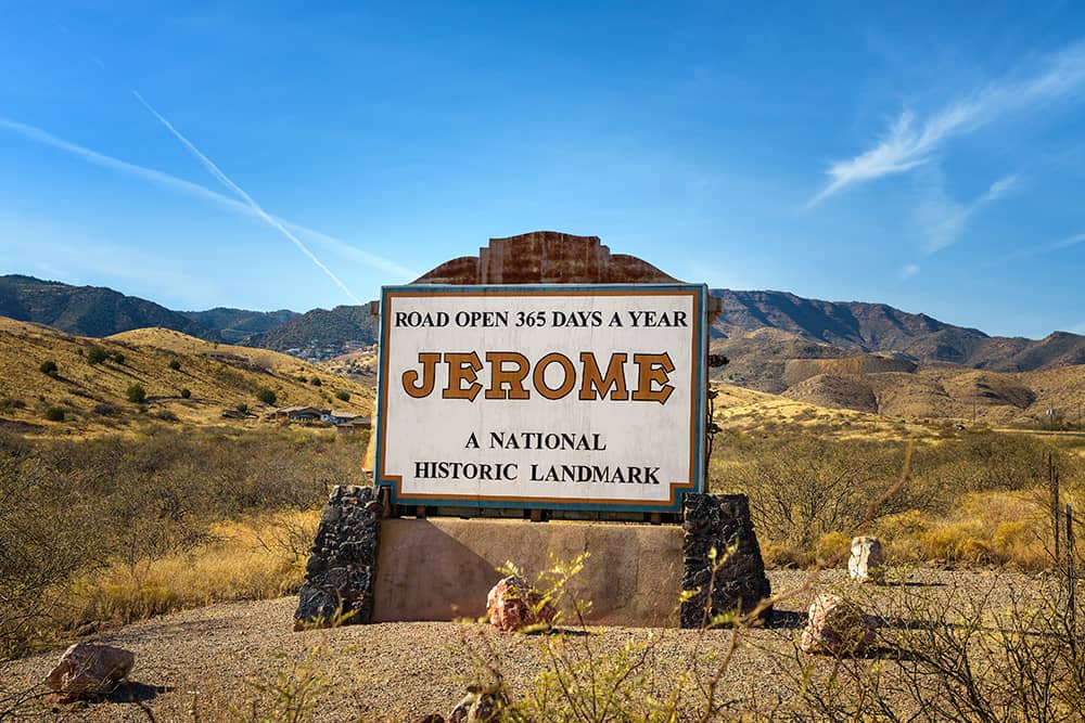 Historic city sign for Jerome, Arizona. Historic city sign for Jerome, Arizona against the backdrop of mountains and blue skies.